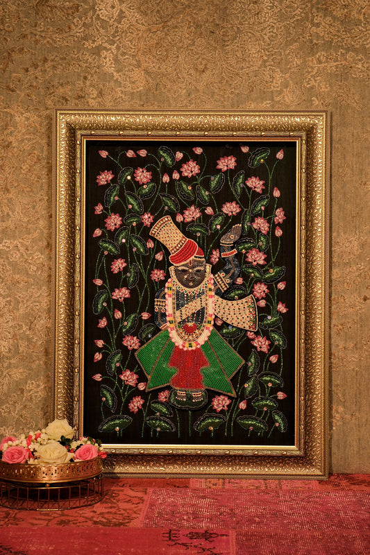Decorative painting of a figure with flowers in a gold frame on a textured wall.
